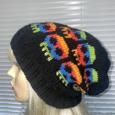Hand knitted slouchy beanie hat black with multicoloured skulls