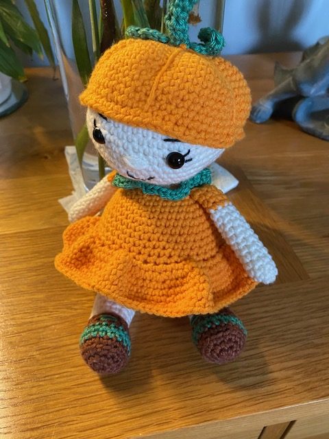 Poppy the Pumpkin Doll wearing her Halloween party dress