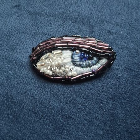 Shiny eye brooch