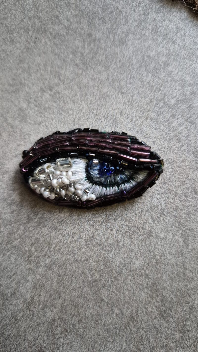 Shiny eye brooch