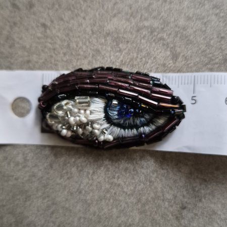 Shiny eye brooch