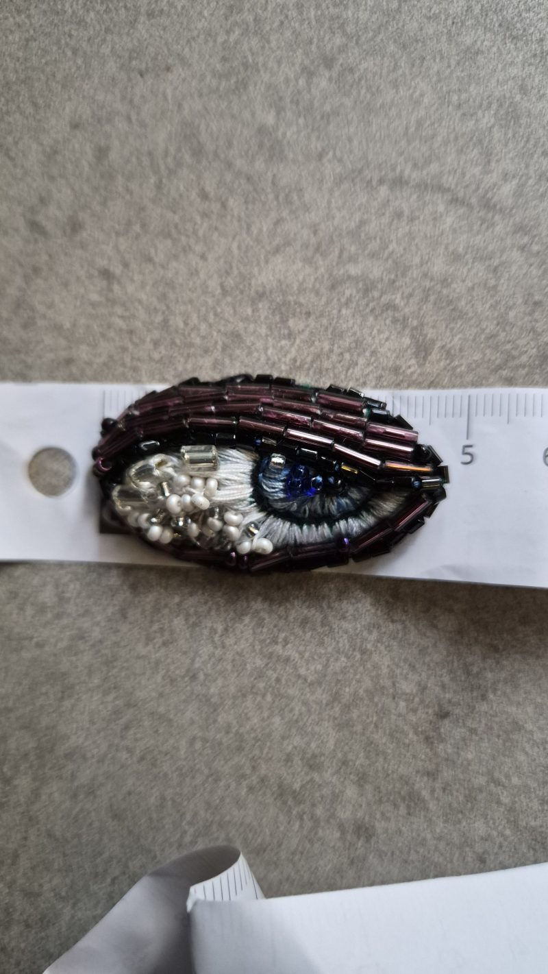 Shiny eye brooch