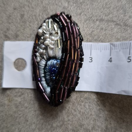 Shiny eye brooch