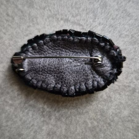 Shiny eye brooch