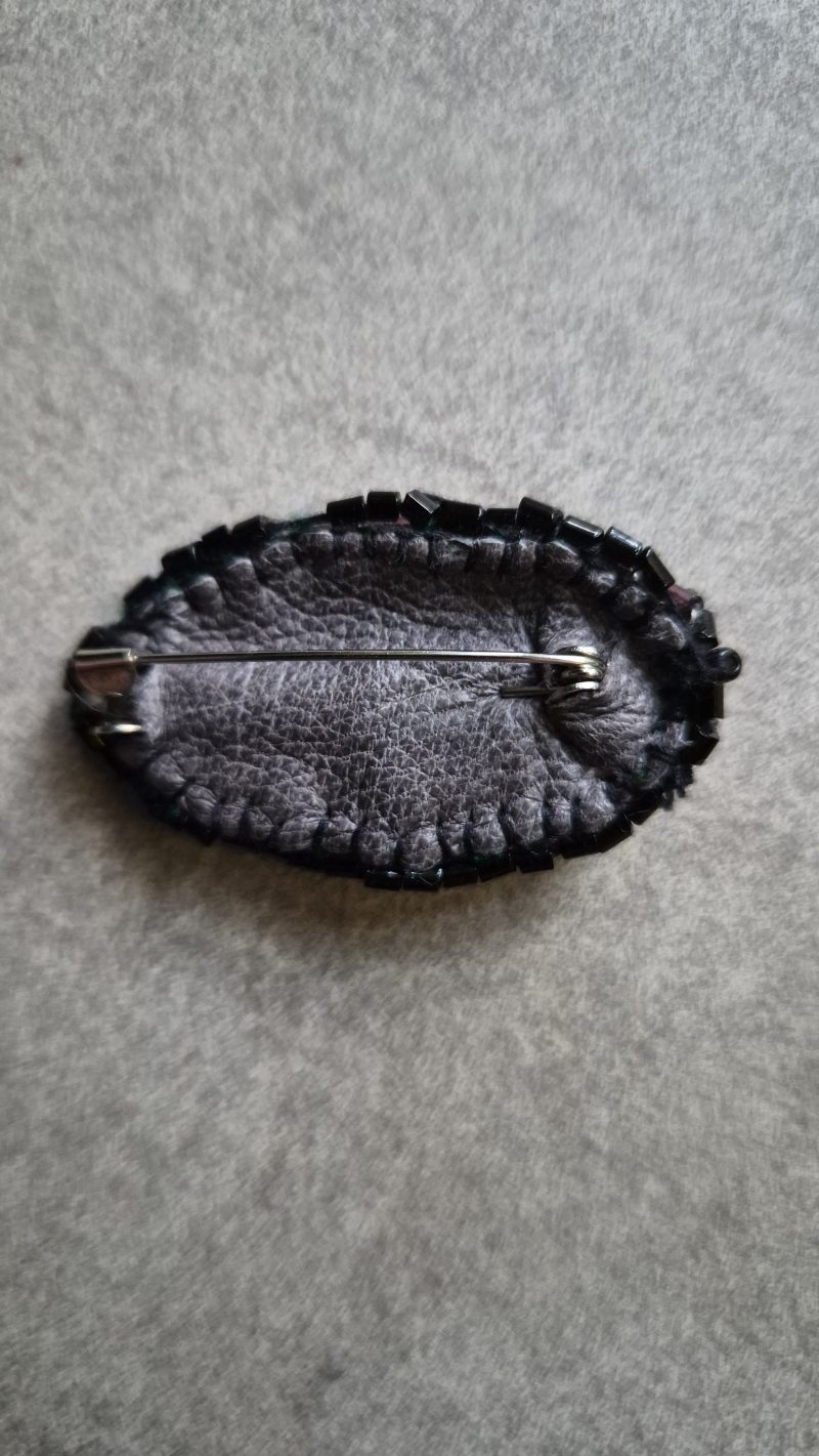 Shiny eye brooch