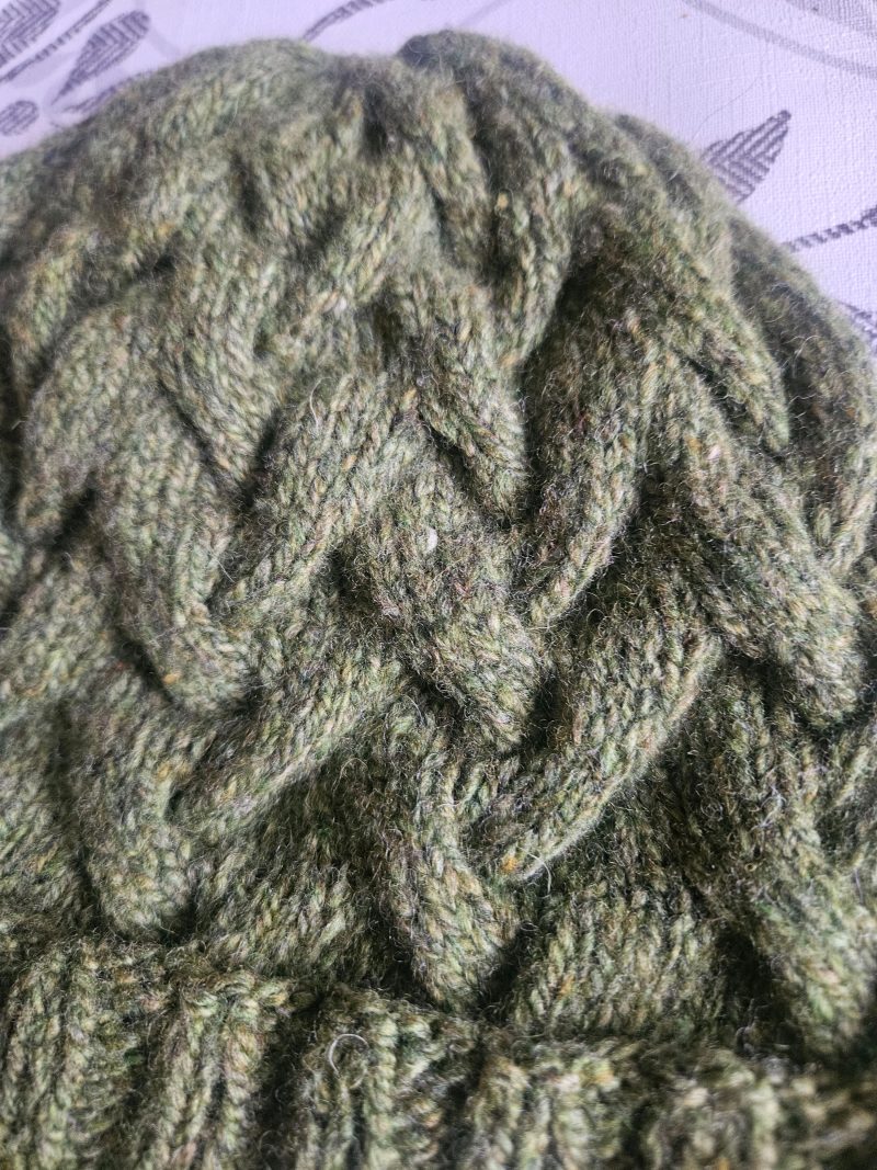 Handknitted 100% wool cabled hat.