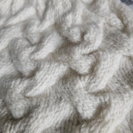 Handknitted 100% wool cabled hat.