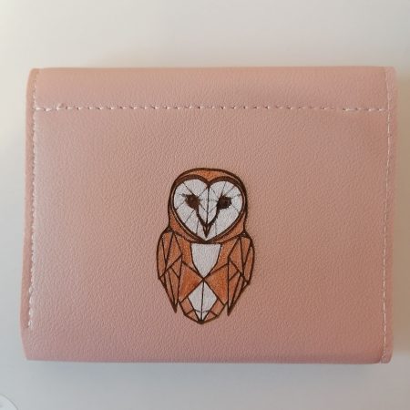 Little owl on a pink purse/wallet