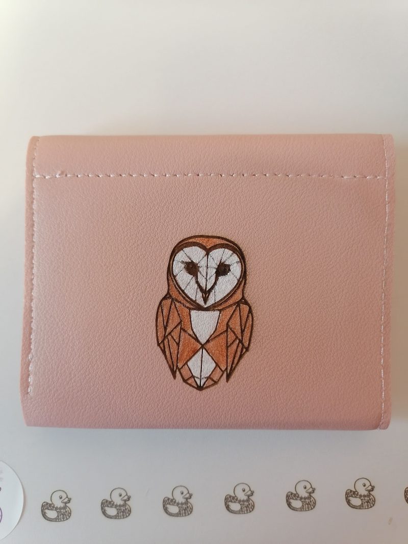 Little owl on a pink purse/wallet