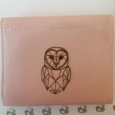 Little owl on a pink purse/wallet