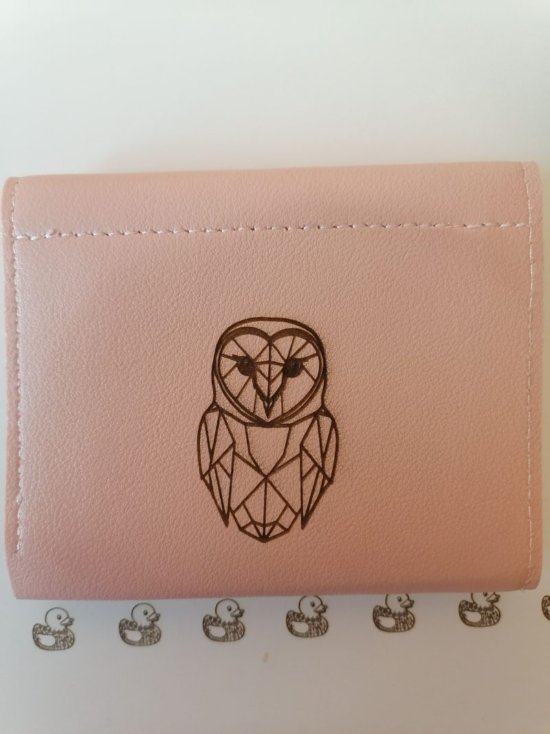 Little owl on a pink purse/wallet