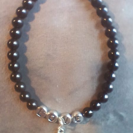 Hand-made bracelet made from natural gemstones with charms.