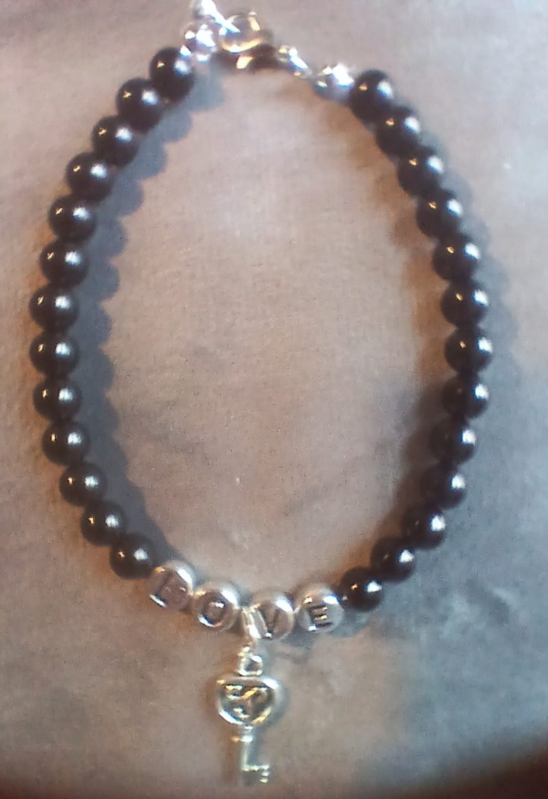 Hand-made bracelet made from natural gemstones with charms.