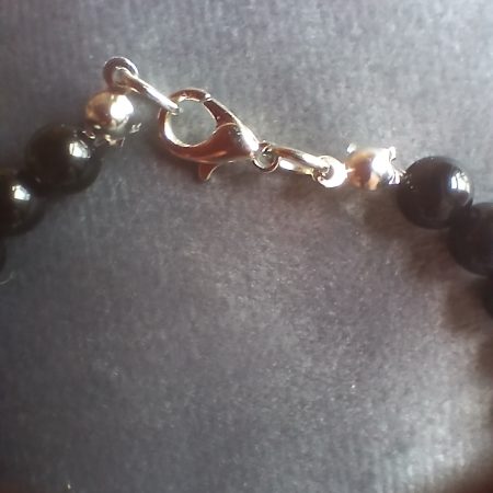 Hand-made bracelet made from natural gemstones with charms.