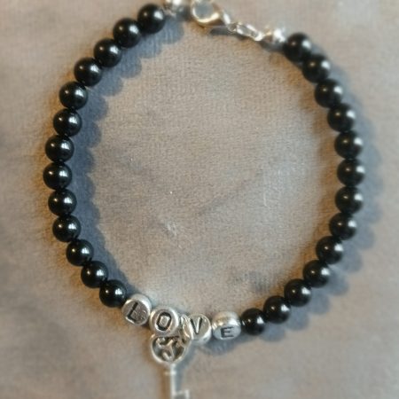 Hand-made bracelet made from natural gemstones with charms.
