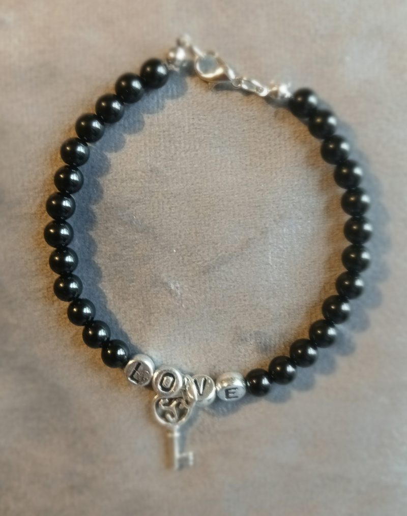 Hand-made bracelet made from natural gemstones with charms.