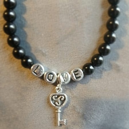 Hand-made bracelet made from natural gemstones with charms.