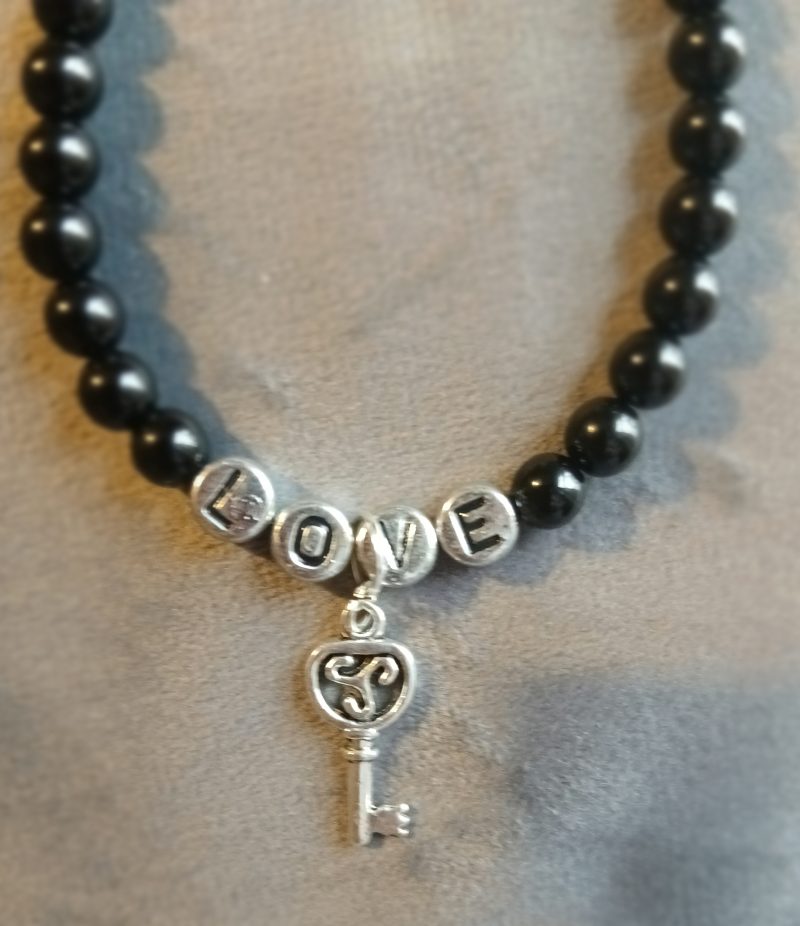 Hand-made bracelet made from natural gemstones with charms.