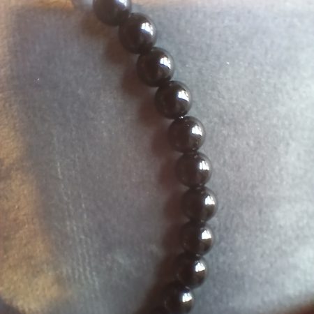 Hand-made bracelet made from natural gemstones with charms.