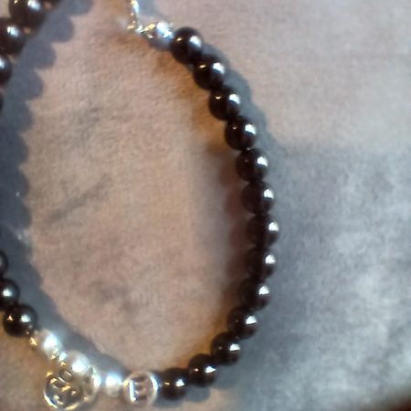 Hand-made bracelet made from natural gemstones with charms.