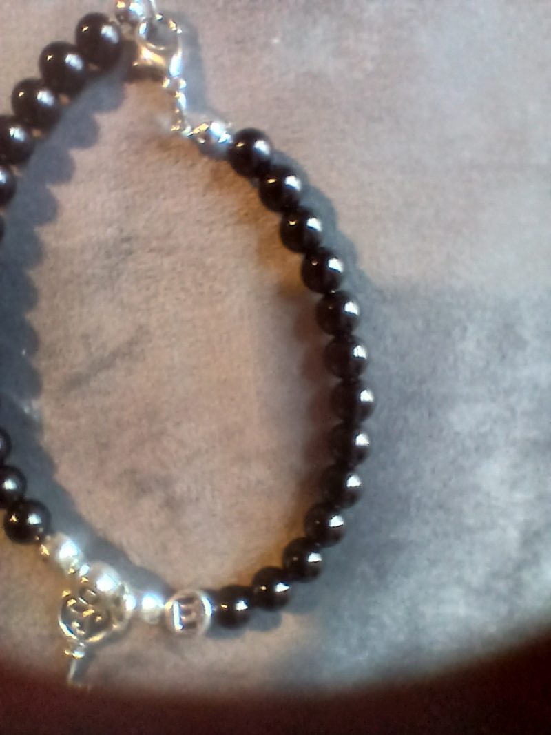 Hand-made bracelet made from natural gemstones with charms.