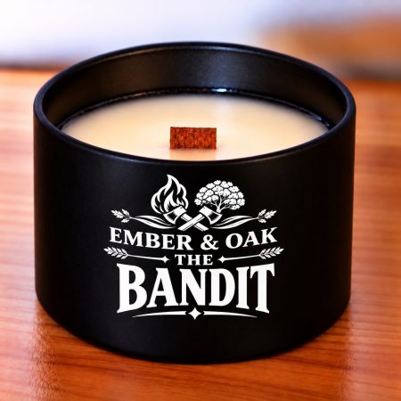 Unlit The Bandit candle in a black jar, showing pale wax, a wooden wick and the Ember & Oak label.