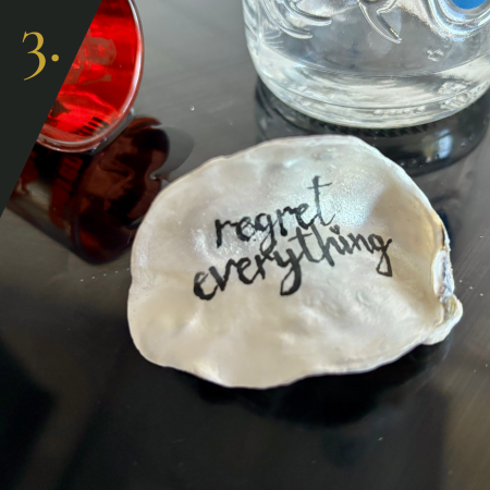 SHUCKED's oyster shell edition no.3, with message "regret everything”